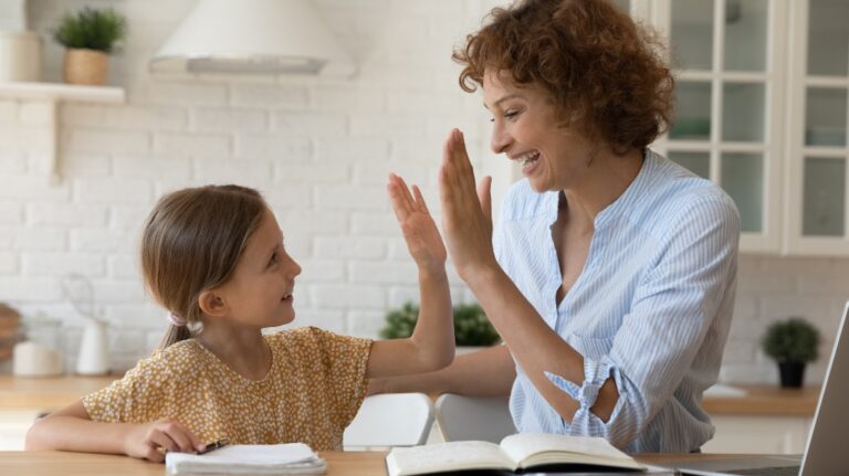 Excited mother give high five to small daughter