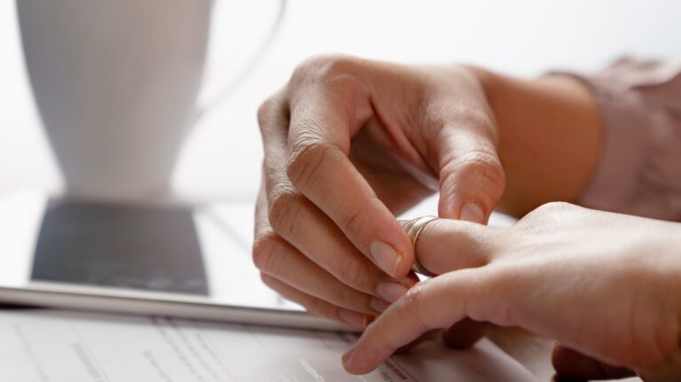 woman hands removing a ring from her finger