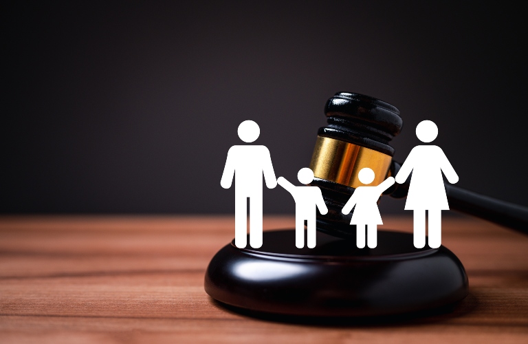 white family figures against the background of a judge's gavel