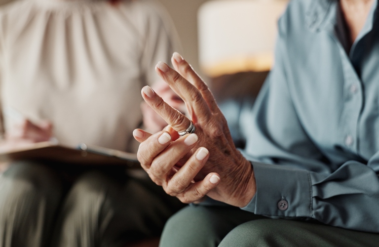 woman touching her wedding ring while talking to lawyer