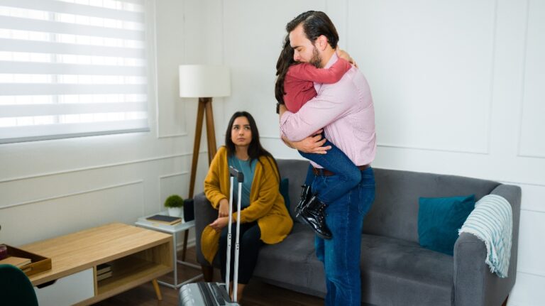 man hugging his young daughter and saying goodbye while moving out