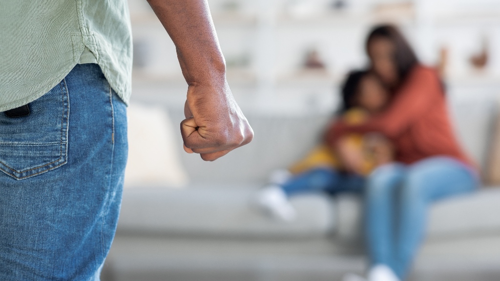 Man threatening wife and daughter with his fist