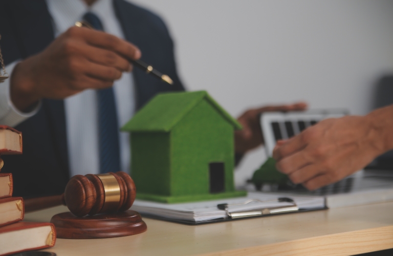 Auctioneer knocks down property sale by sample house and lawyer's gavel